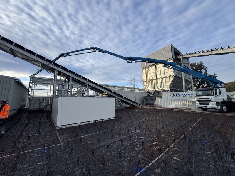 A.F. Concrete Pumping boom pump reaching over a building site