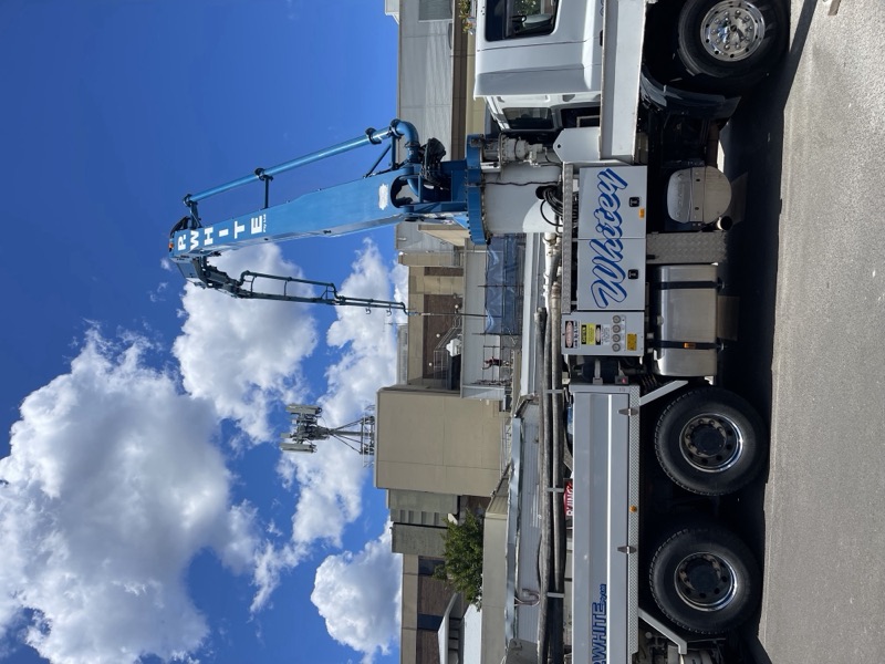 A.F. Concrete Pumping boom pump with the boom raised in a street