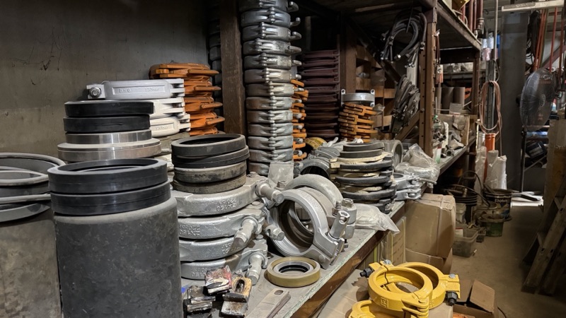 Coils of delivery hose stacked in the yard