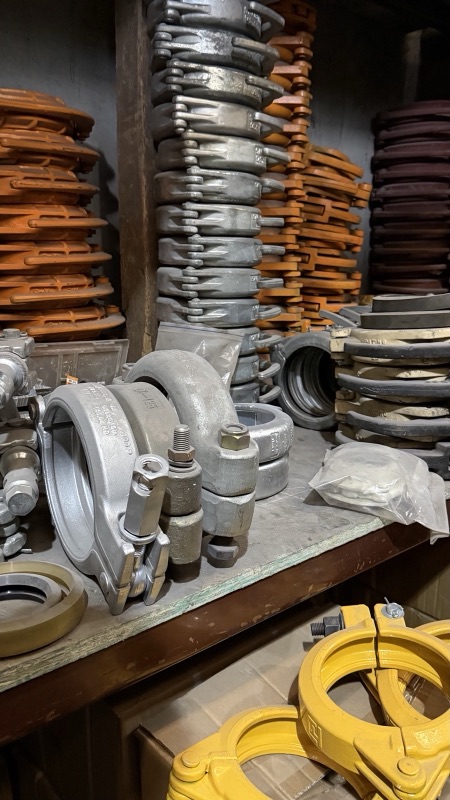 Clamps and orange gaskets laid out on the parts shelf