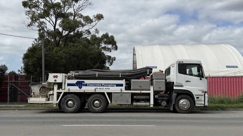 A.F. Concrete Pumping line pump truck parked in a street, side on